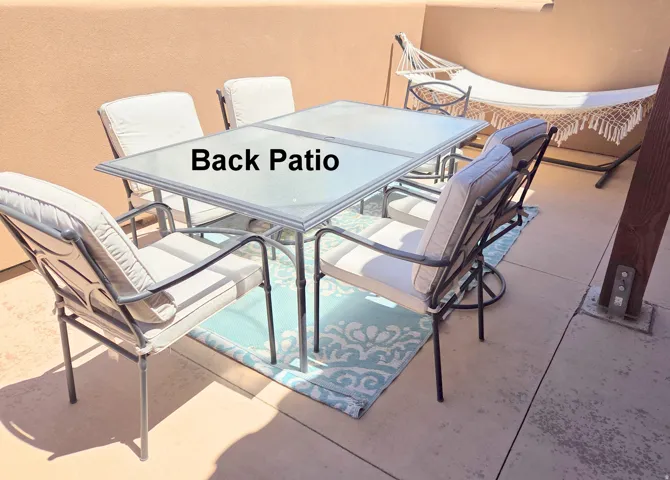 Concrete patio dining just off the kitchen with stucco walls
