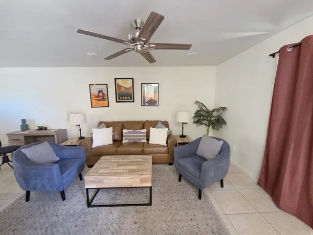 Living area featuring tile flooring, a ceiling fan with light, and recessed lighting