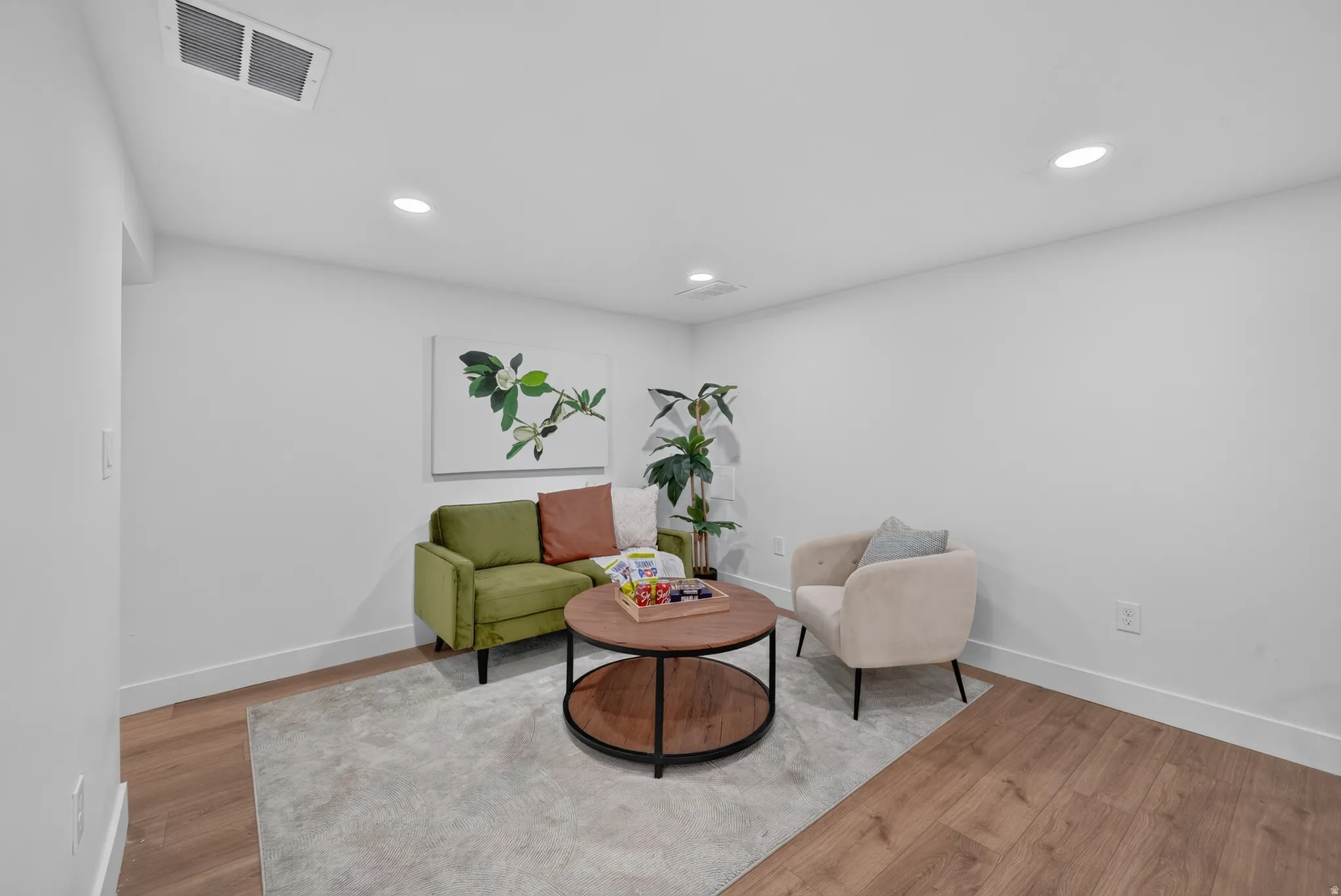 Open concept living area with wood-finish flooring, recessed lighting, and white baseboards