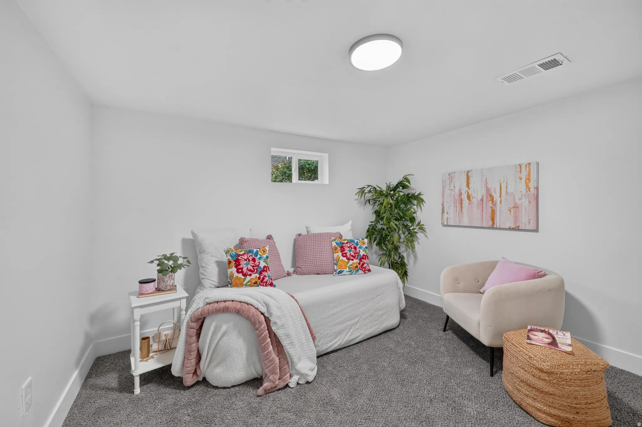 Carpeted room with white walls, a single window, and a flush-mount ceiling light