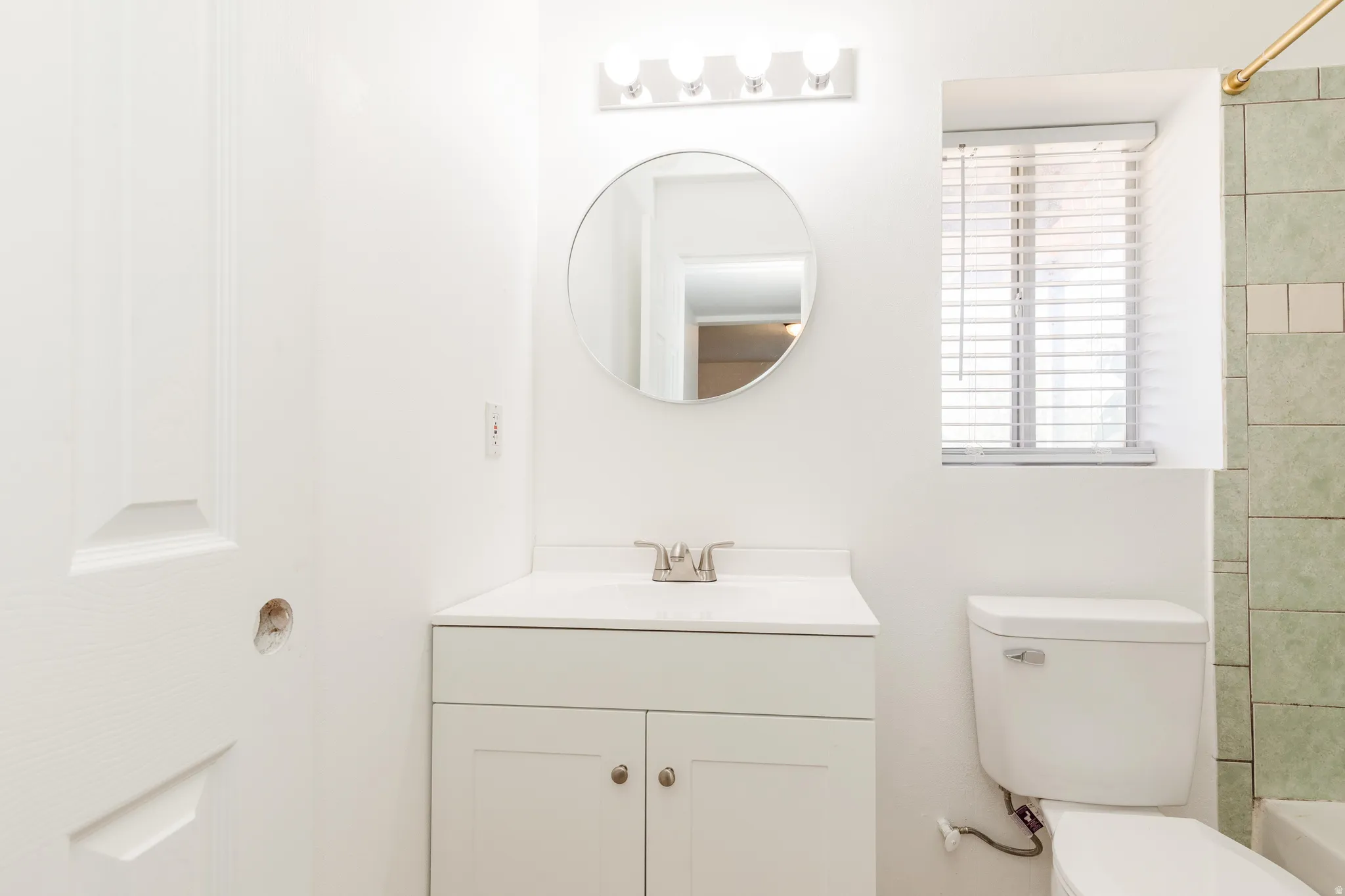 Bathroom featuring a vanity with a white countertop and base cabinet