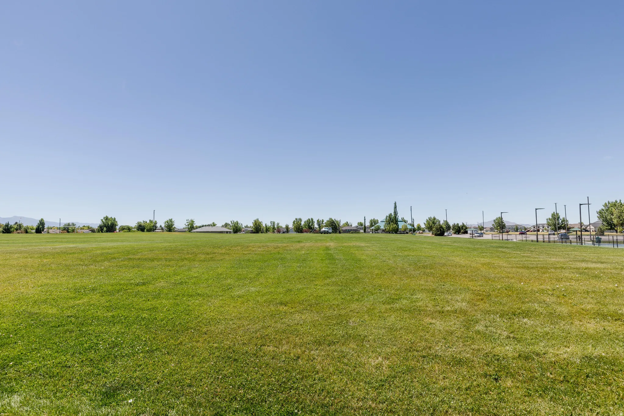 Expansive green space featuring a large grassy field