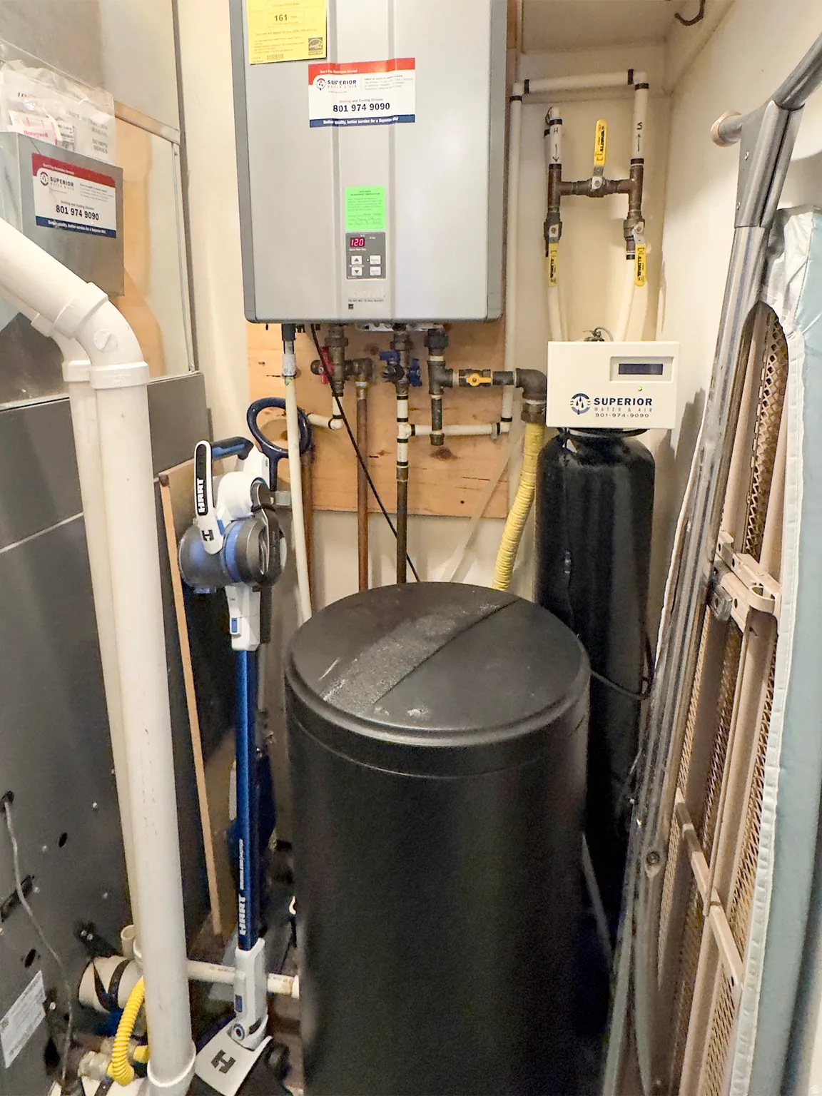Tankless water heater, water softener, and HVAC system with exposed ductwork and PVC piping