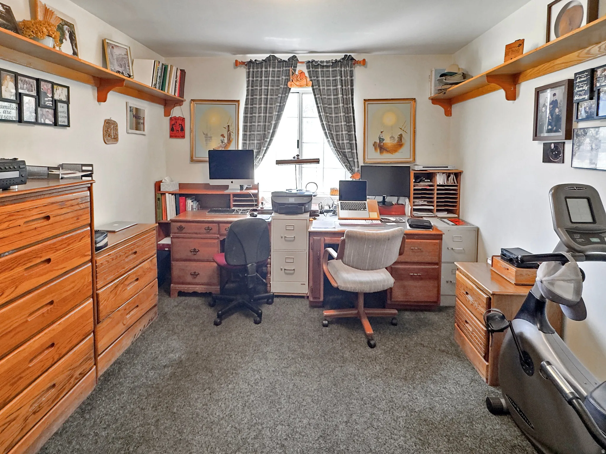Dedicated office space featuring two built-in workstations with ample storage