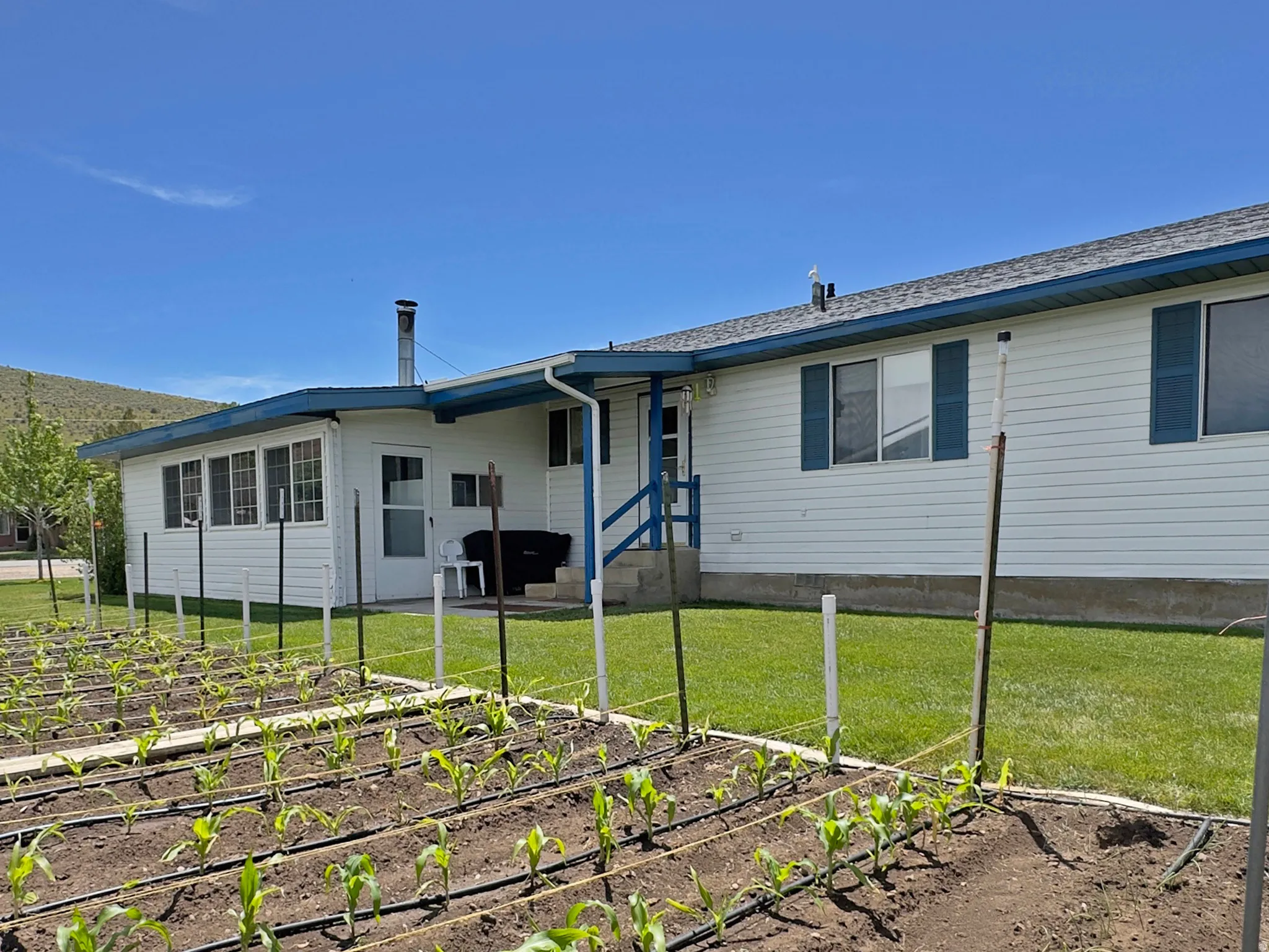 Expansive garden area featuring planted rows and an irrigation system