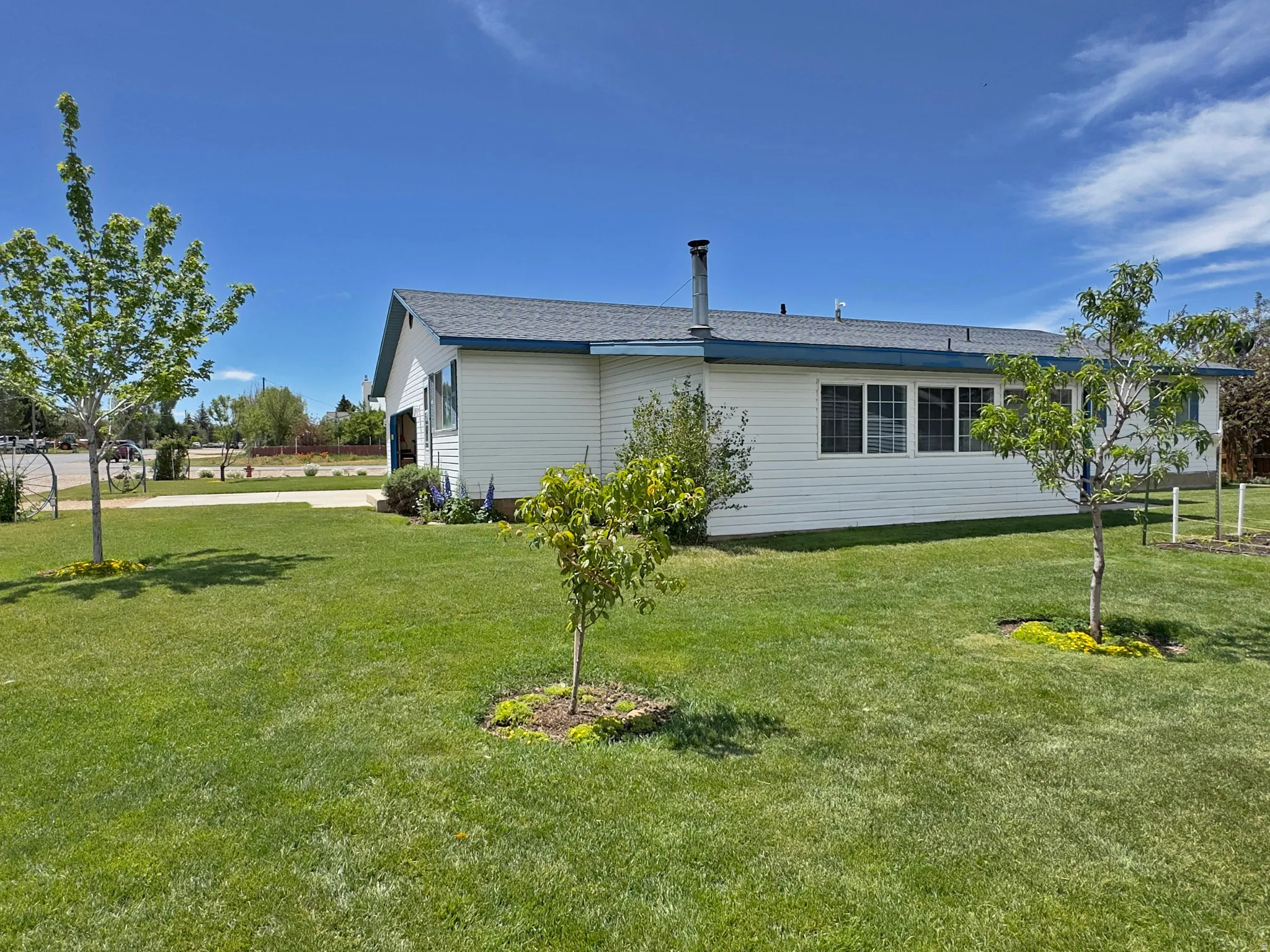 White siding exterior with a dark shingle roof