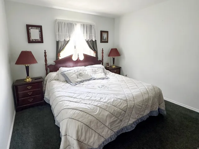 Bedroom featuring wall-to-wall carpeting and neutral wall tones