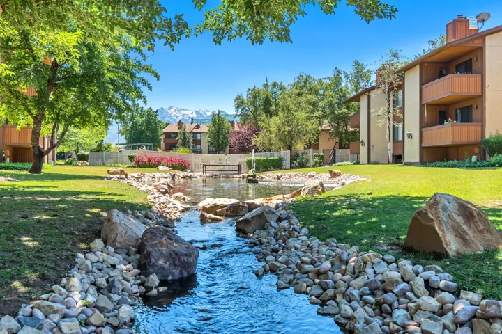 Water feature with rock-lined stream leading to a pond
