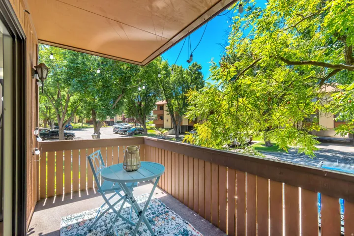 Private balcony featuring a wood-panel railing and a concrete floor