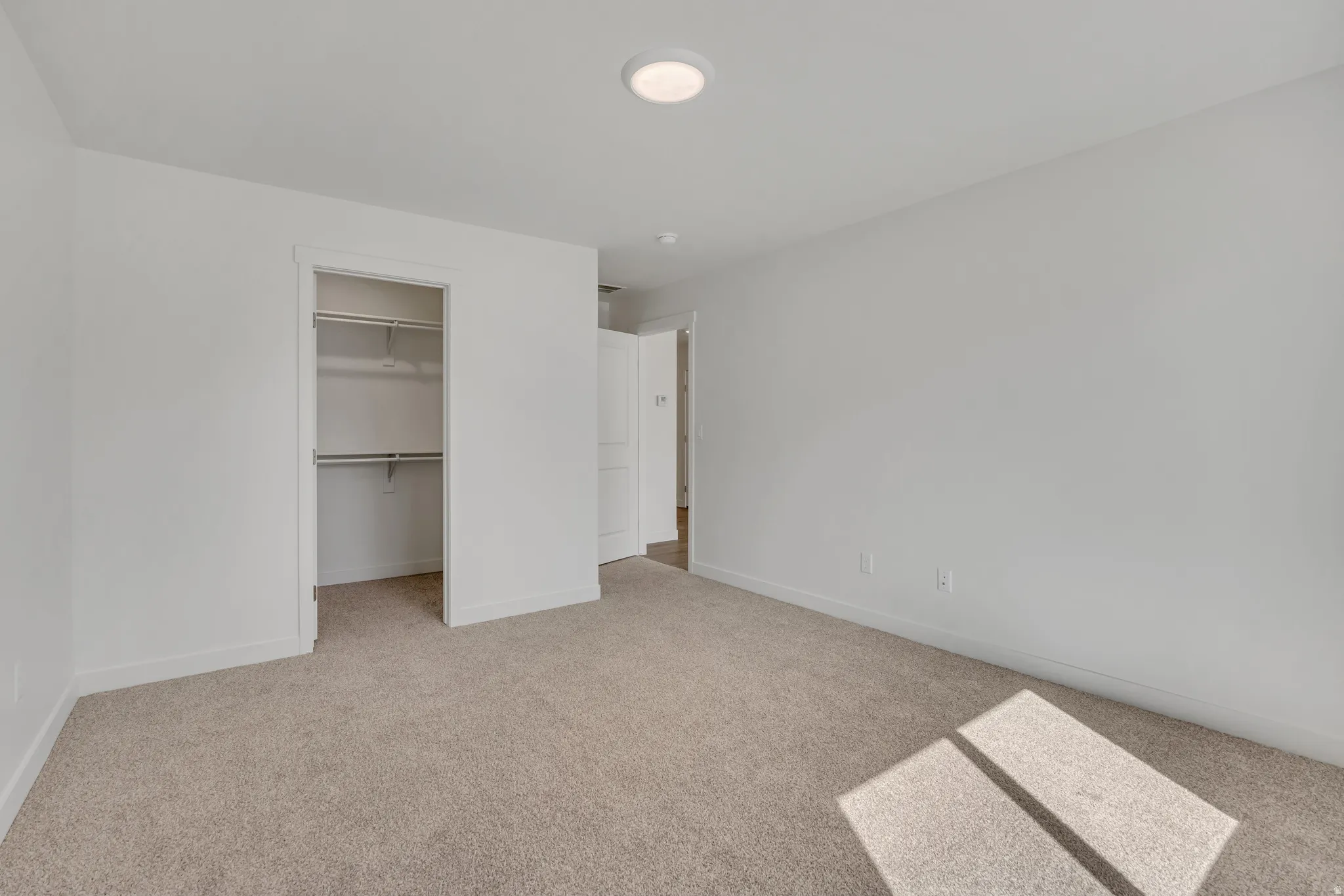 Carpeted interior space featuring a recessed ceiling light