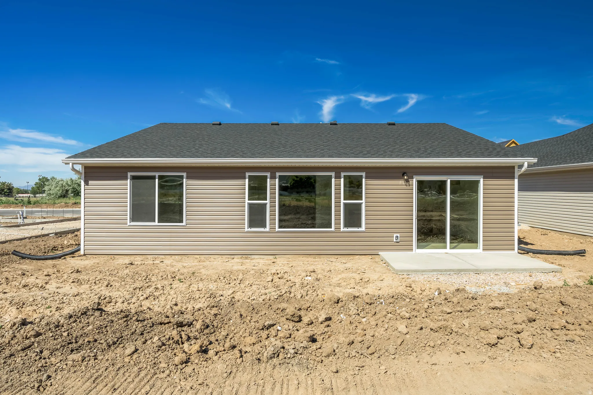 Rear exterior featuring horizontal siding in a neutral tone