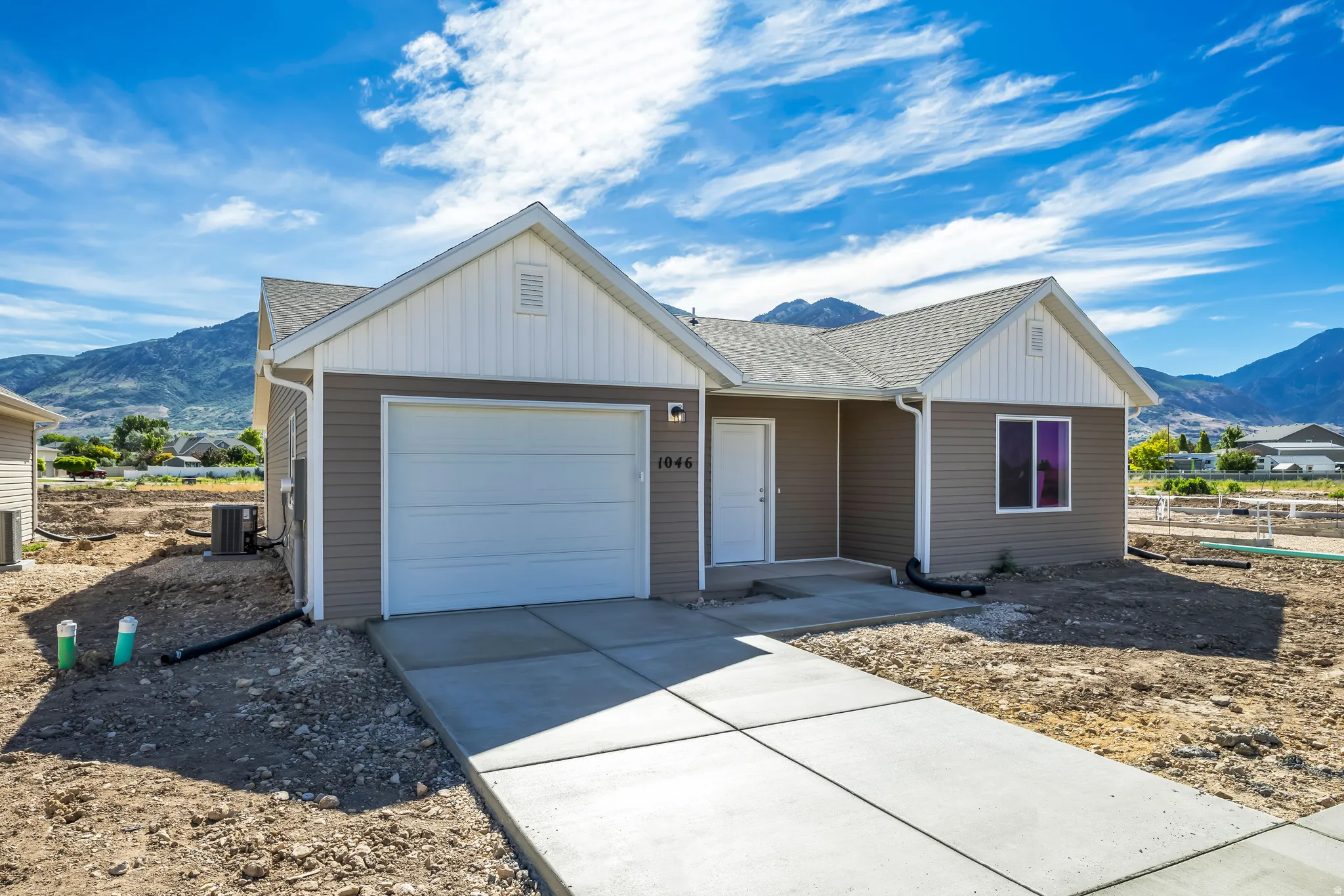 Contemporary single-story residence with a two-tone exterior and an attached garage