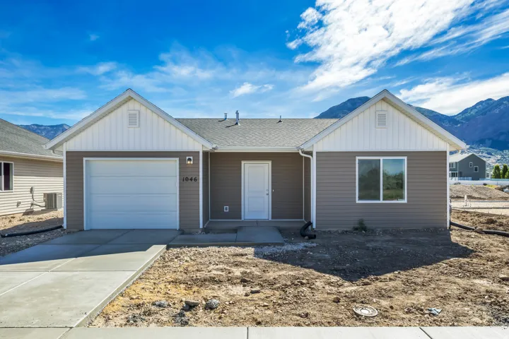 Contemporary ranch-style residence featuring horizontal siding, white trim, a single-car garage, and a concrete driveway