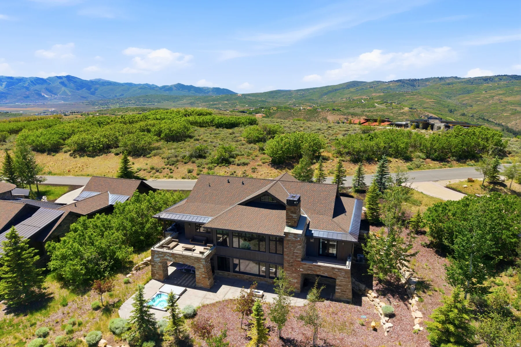Contemporary residence featuring a multi-level design, stone accents, and a prominent chimney