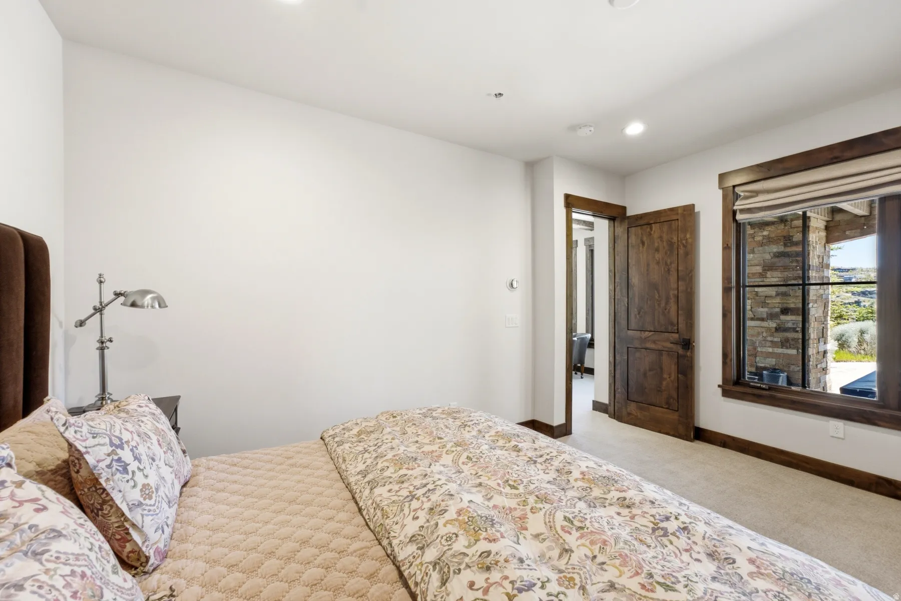 Interior room featuring a large window with stone detailing and dark wood trim