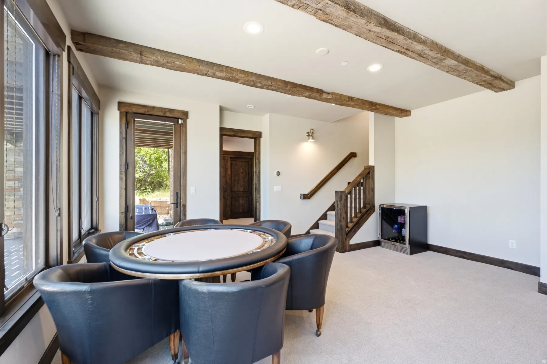 Recreational space featuring exposed wood beams, recessed lighting, and a built-in beverage cooler