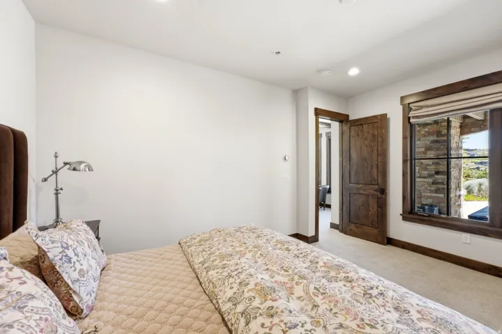 Interior room featuring a large window with stone detailing and dark wood trim