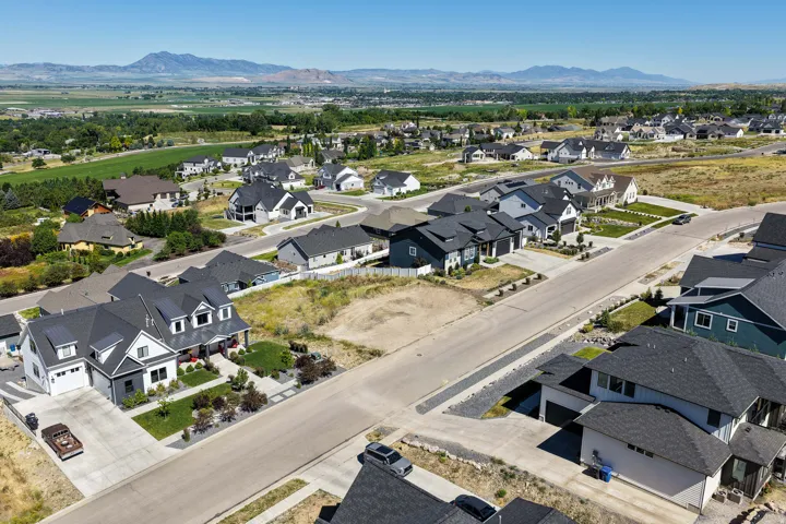 Contemporary residential development featuring a variety of architectural styles, paved streets, and manicured landscaping