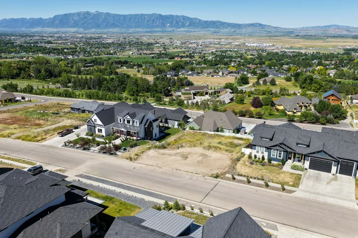Aerial perspective showcasing a developed residential area with mountain scenery