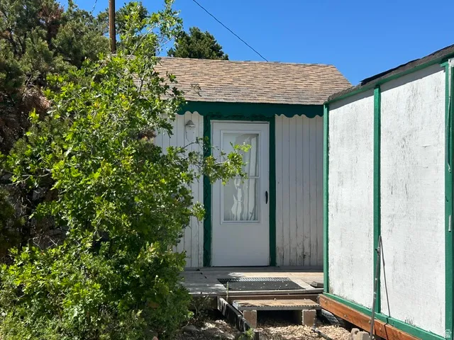 Exterior siding with vertical paneling and a scalloped trim detail