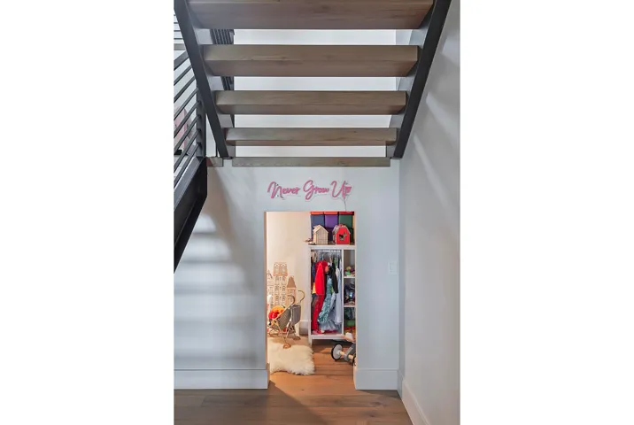 Open-tread staircase with wood-finish steps and black metal railings