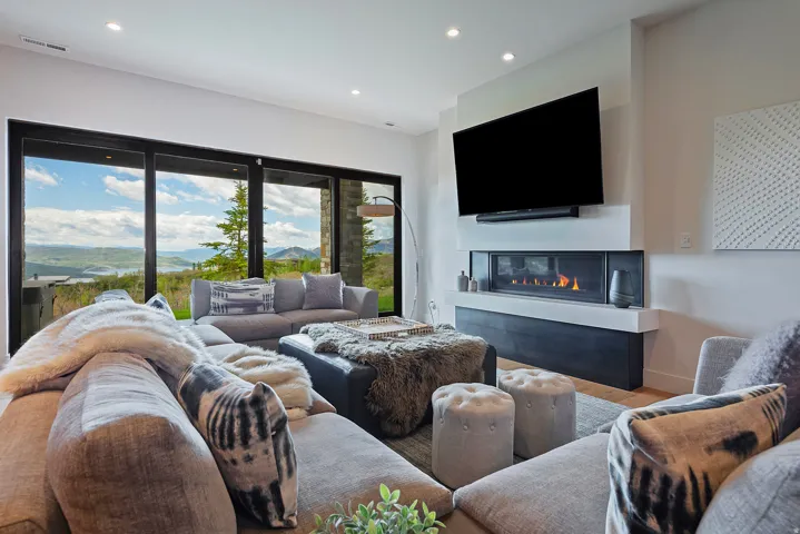 Living area with expansive sliding glass doors showcasing distant mountains and a body of water