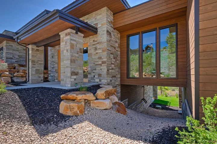 Modern facade featuring stone veneer and horizontal wood-finish siding