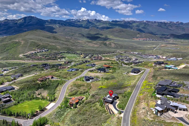 Property situated on a winding paved road with mountain scenery