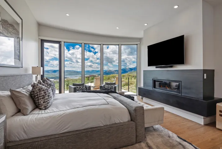 Expansive floor-to-ceiling windows featuring mountain and cloud scenery