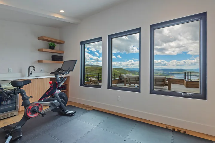 Expansive windows showcasing panoramic mountain and water scenery