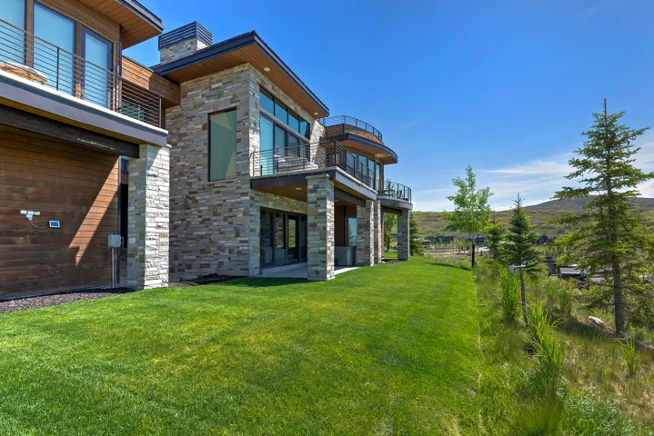 Contemporary residence featuring stone and wood-finish siding