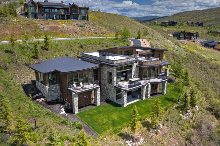 Contemporary multi-level residence featuring extensive stone and wood paneling
