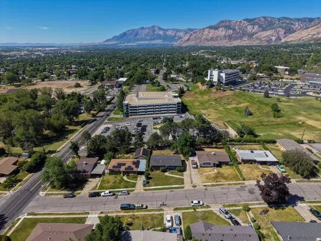 Residential neighborhood featuring established homes with mature landscaping, surrounded by expansive green spaces