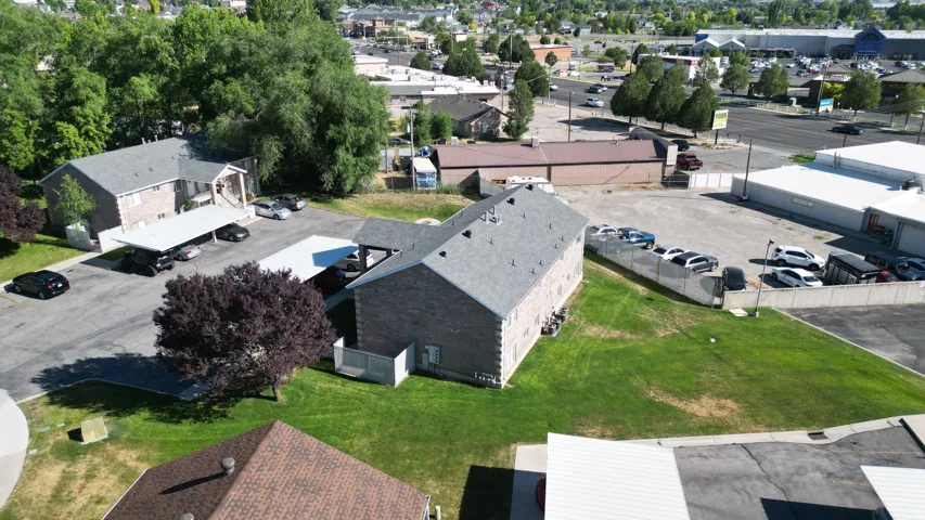 Brick-clad multi-unit buildings with shingle roofing
