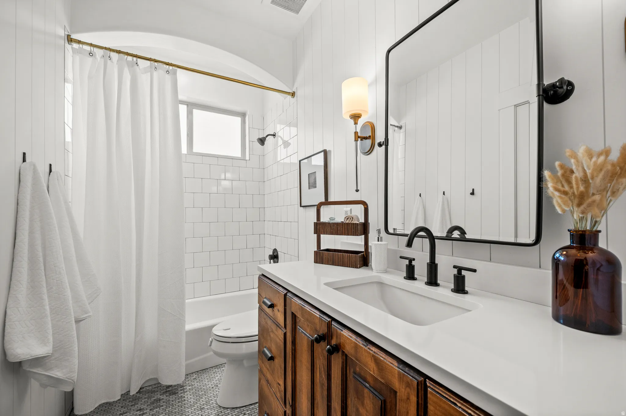 Well-appointed and move-in ready, this full bathroom is designed to be enjoyed for years to come.