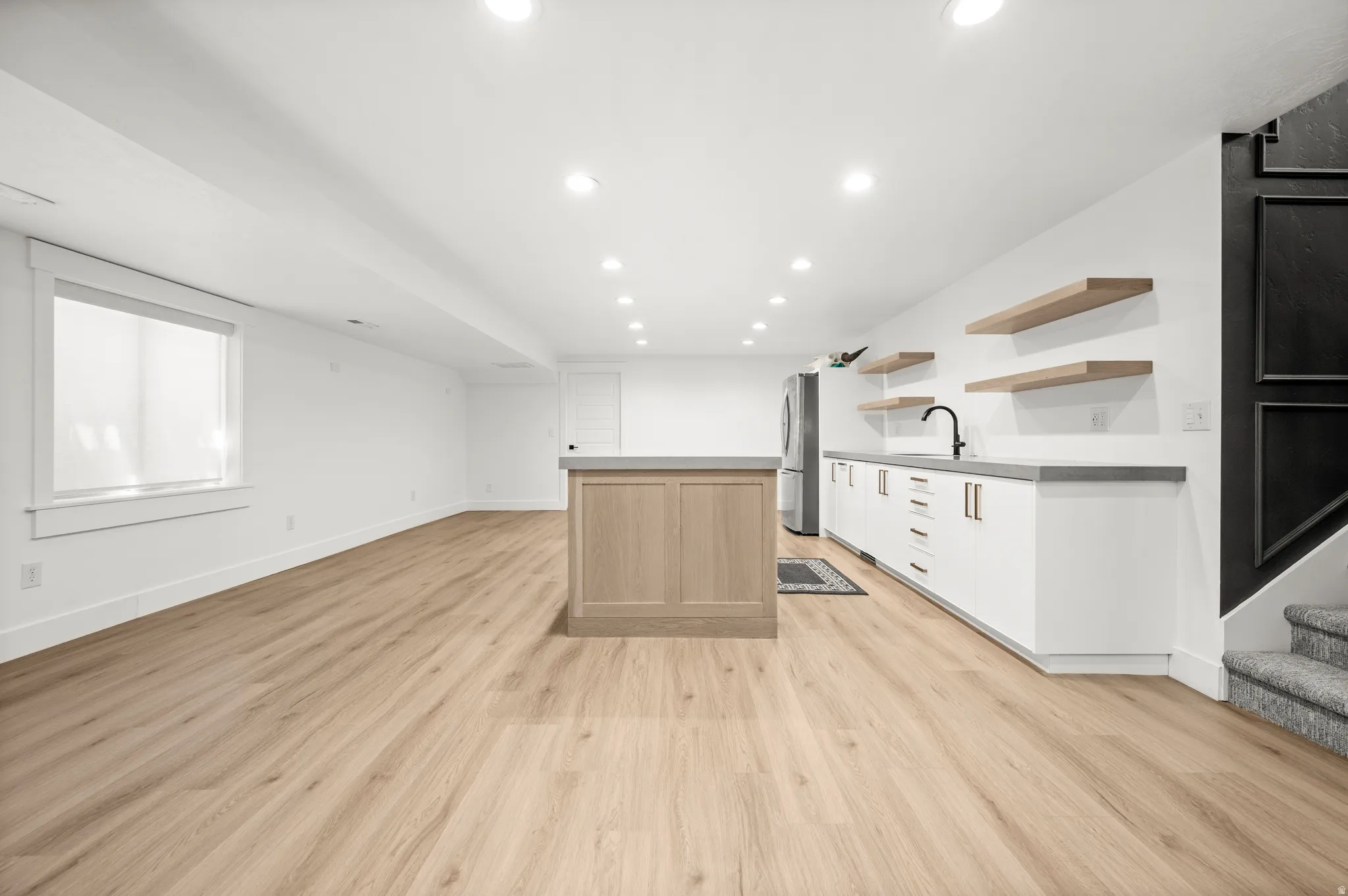 Whether hosting friends, watching the big game, or enjoying family game night, this inviting family room and kitchenette create the ideal space to gather and connect.