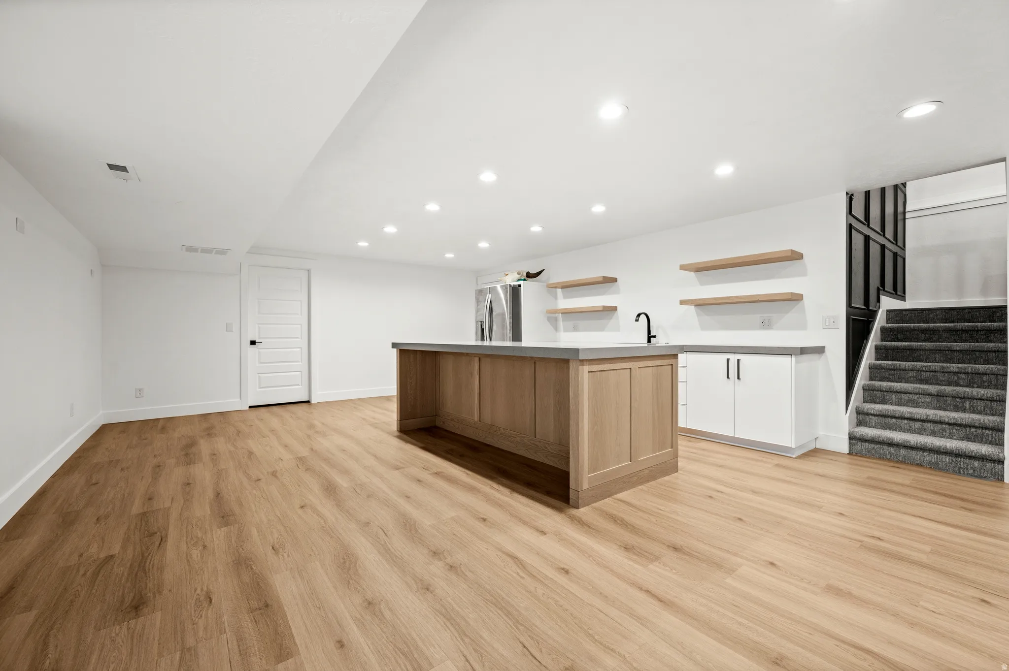 Designed with both comfort and functionality in mind, this expansive family room provides plenty of space for everyone to gather and enjoy.