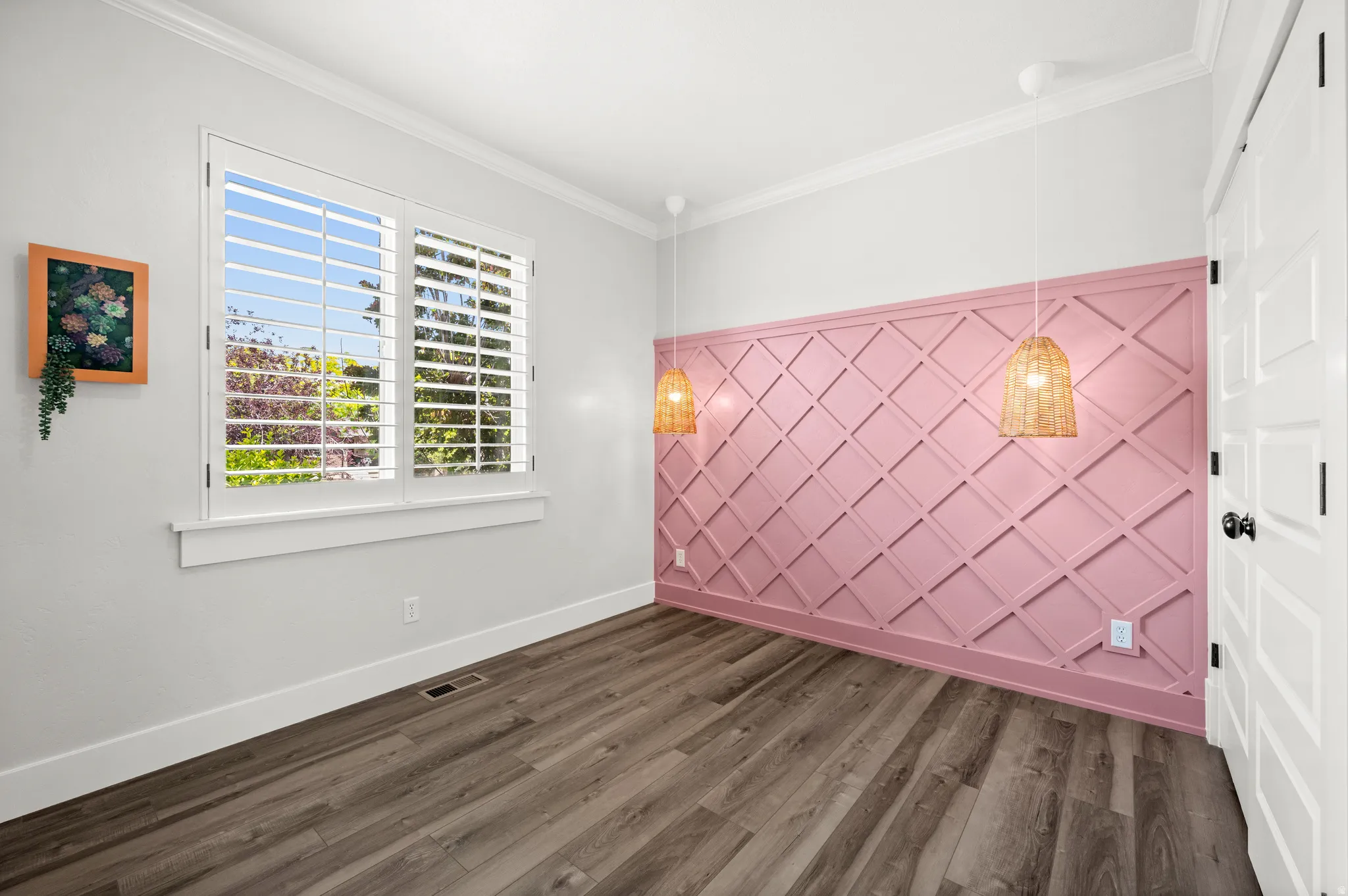 With its custom feature wall and decorative lighting, this room is ready to become a favorite retreat, creative space, or bedroom.