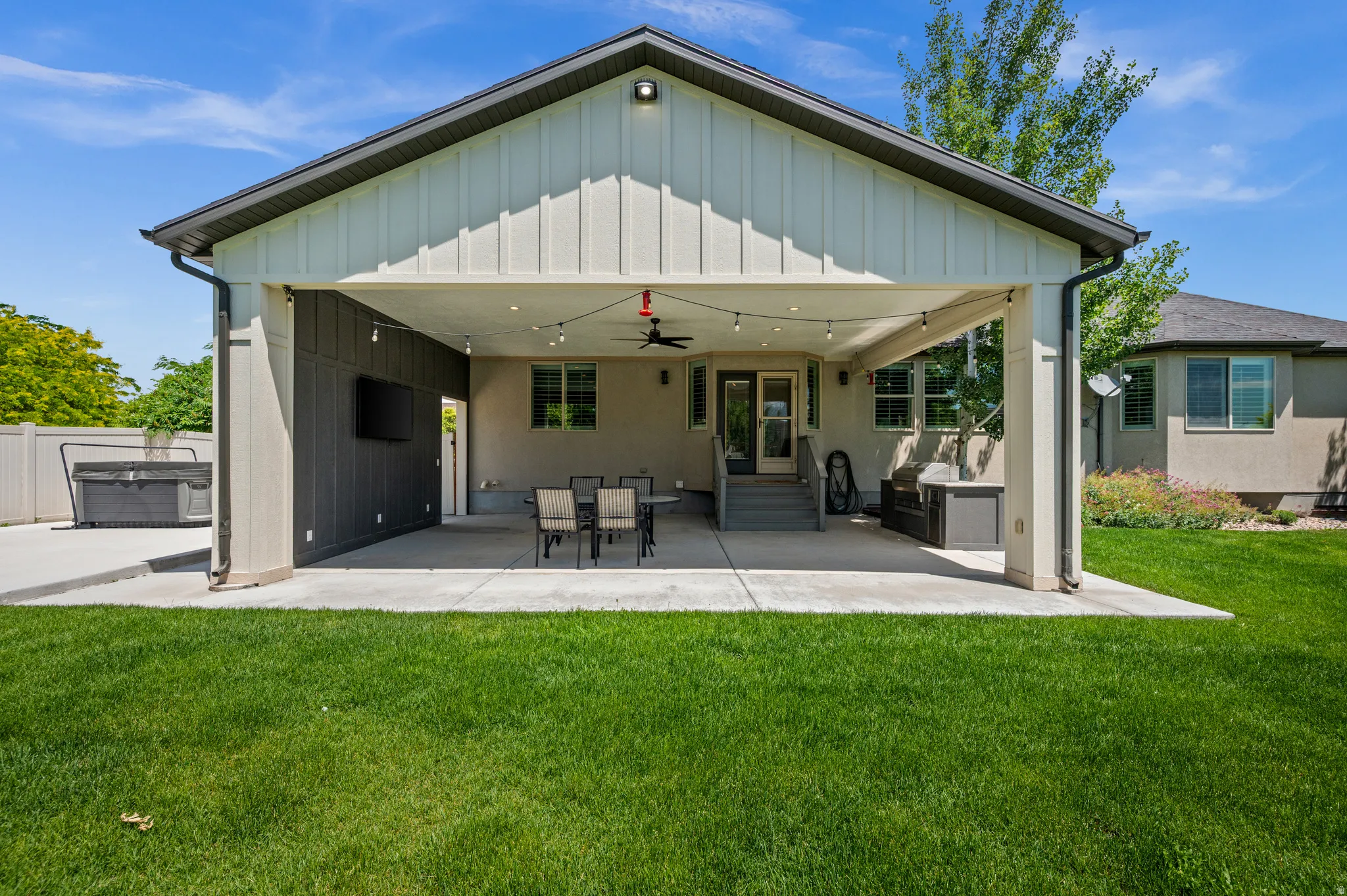 The ultimate outdoor gathering space, this covered patio offers comfort, shade, and plenty of room to enjoy time with the people who matter most.