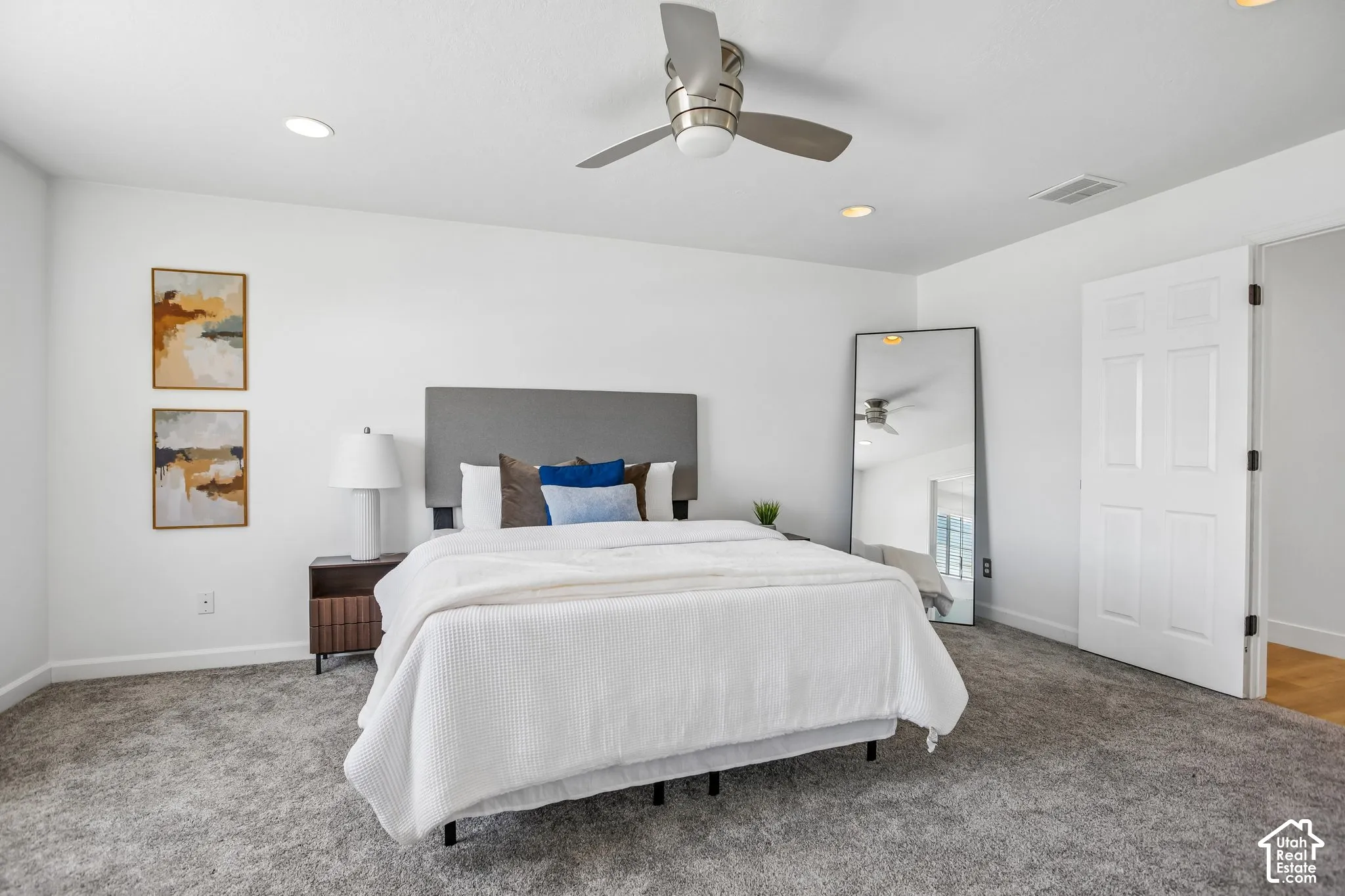 Spacious room featuring gray carpet, recessed lighting, and a ceiling fan