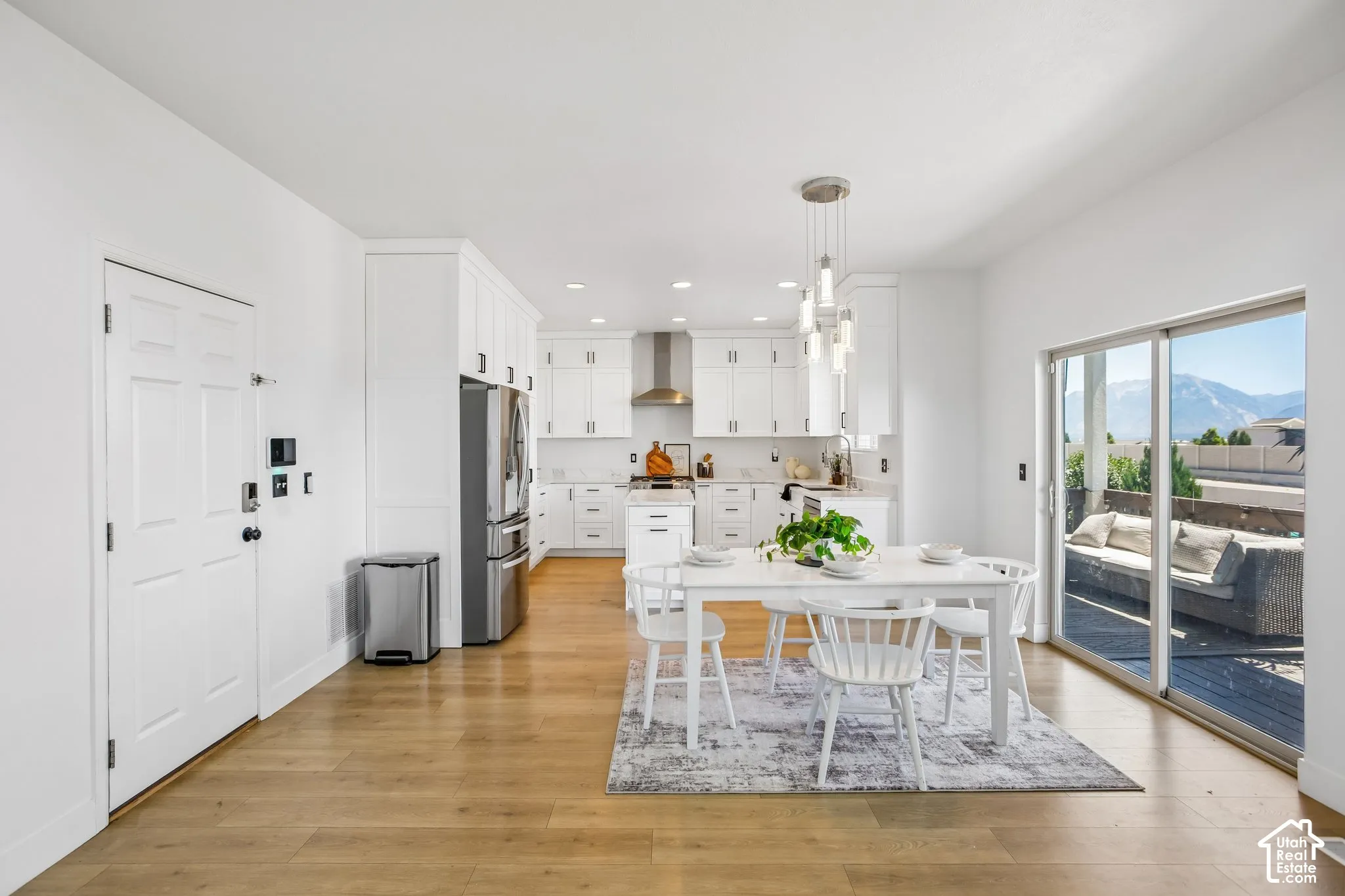 Open-concept living space featuring wood-finish flooring and white walls