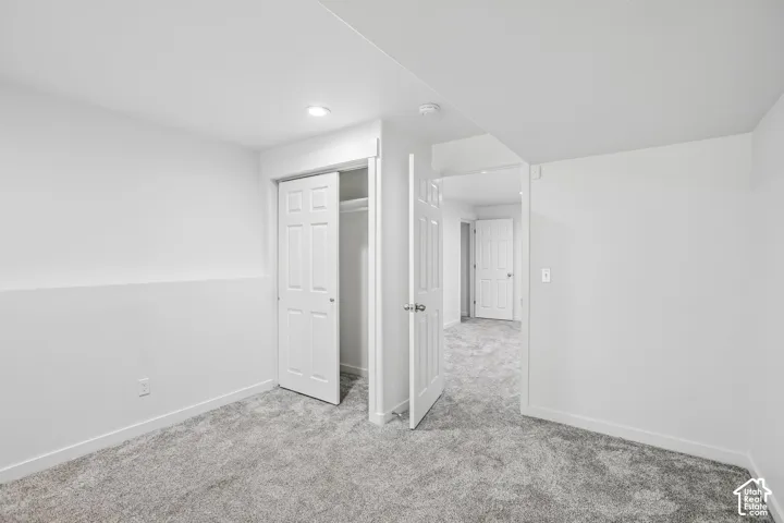 Neutral-toned carpeting and white walls create a bright interior