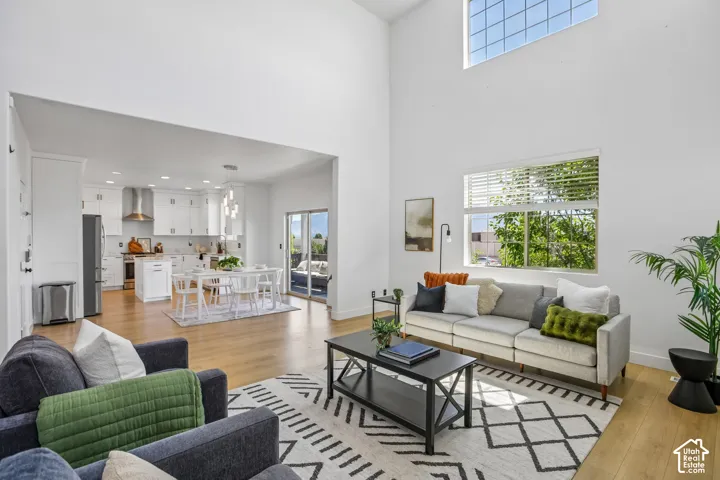 Expansive living area featuring soaring ceilings and wood-finish flooring
