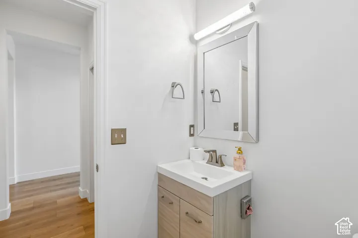 Modern vanity with an integrated sink, brushed nickel faucet, and wood-finish cabinetry