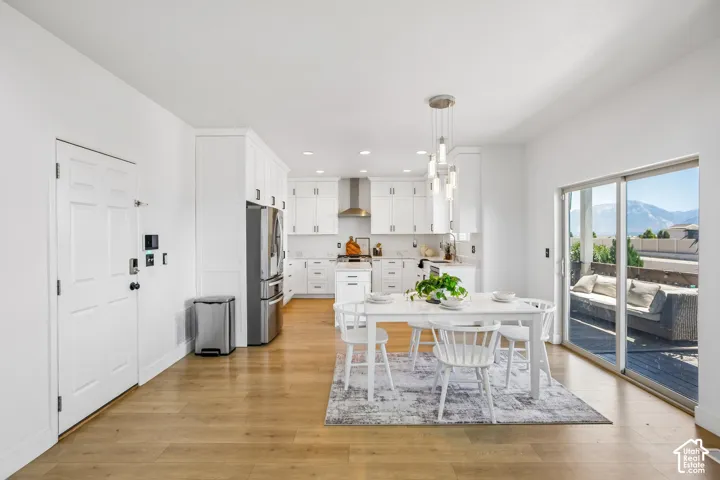 Open-concept living space featuring wood-finish flooring and white walls