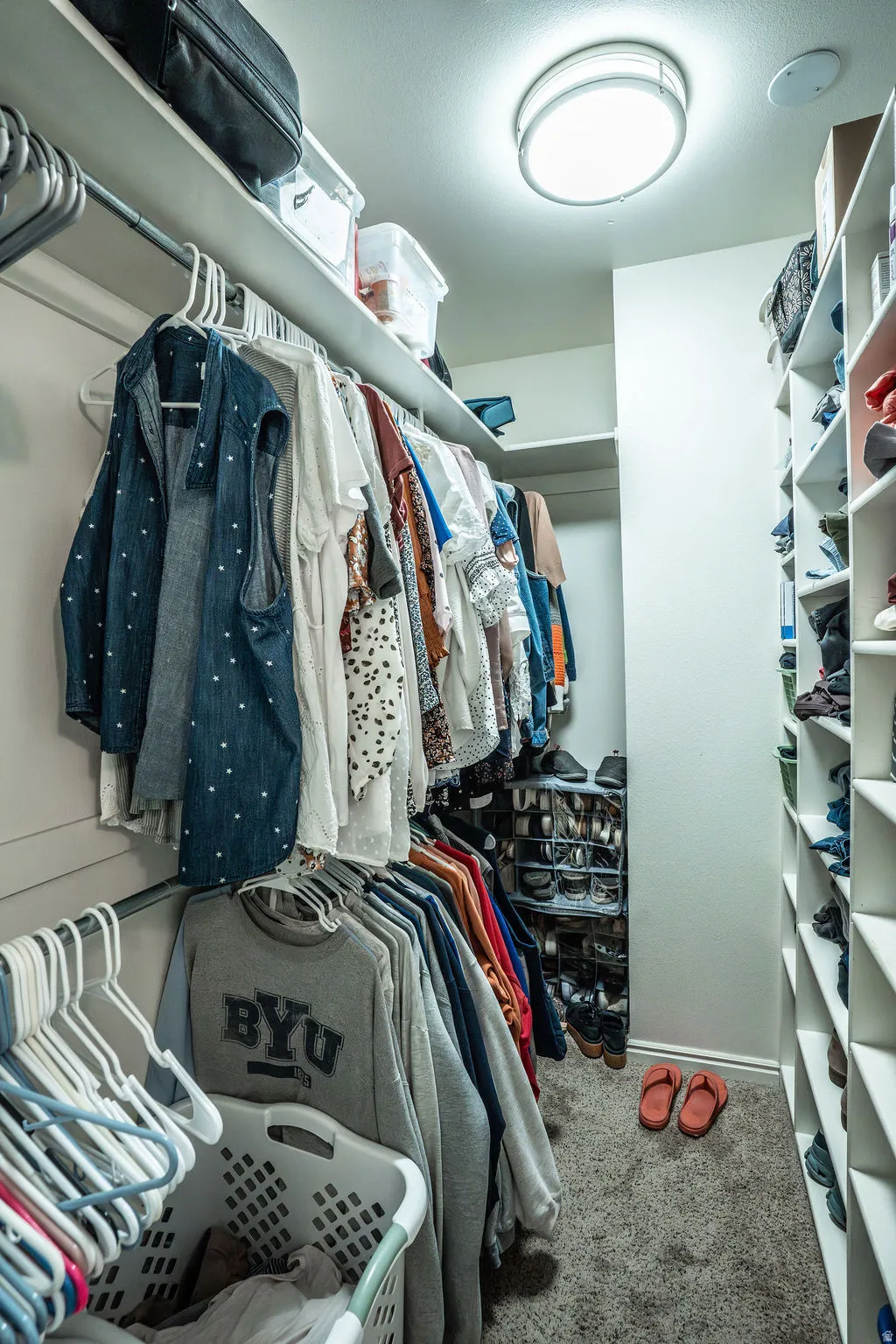 Walk-in closet featuring extensive shelving, hanging rods, and recessed lighting