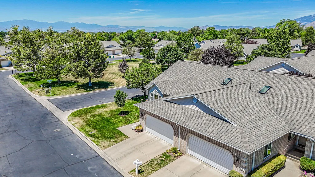 Brick and siding exterior with a multi-car garage and a paved driveway