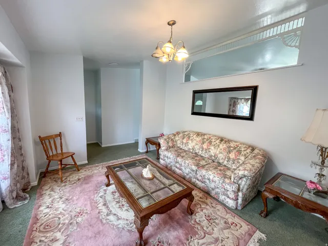 Recessed window feature with decorative trim, overhead lighting, and wall-to-wall carpeting