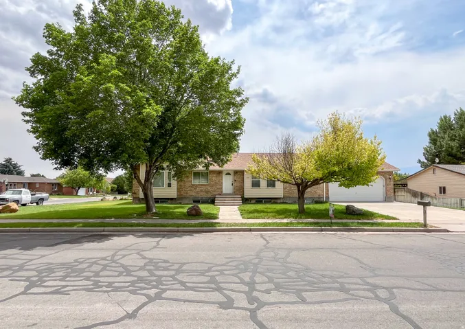 Brick-front residence with a two-car garage and a paved driveway