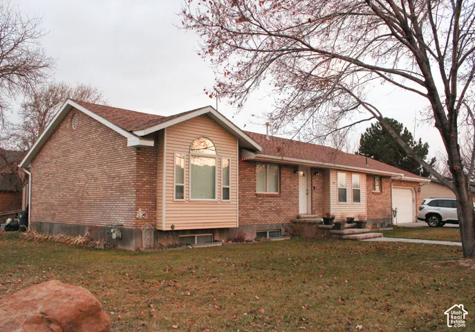 Brick and siding exterior residence featuring a prominent bay window